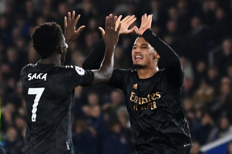 Arsenal's French defender William Saliba (R) and Arsenal's English midfielder Bukayo Saka (L) celebrate their second goal during the English Premie...
