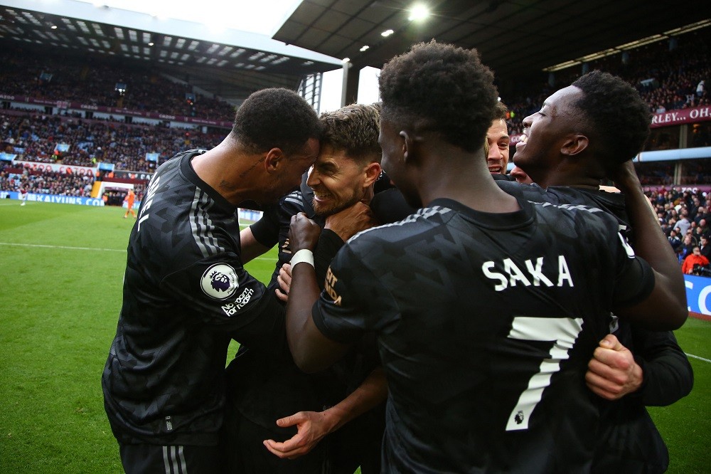 Arsenal's Italian midfielder Jorginho (C) celebrates with teammates after his shot ends up in the net, rebounding off Aston Villa's Argentinian goalkeeper Emiliano Martinez for an own-goal during the English Premier League football match between Aston Villa and Arsenal at Villa Park in Birmingham, central England on February 18, 2023. (Photo by GEOFF CADDICK/AFP via Getty Images)