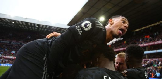 Arsenal's French defender William Saliba (C) celebrates after a shot from Arsenal's Italian midfielder Jorginho ends up in the net, rebounding off Aston Villa's Argentinian goalkeeper Emiliano Martinez for an own-goal during the English Premier League football match between Aston Villa and Arsenal at Villa Park in Birmingham, central England on February 18, 2023. - Arsenal won the game 4-2. (Photo by GEOFF CADDICK/AFP via Getty Images)