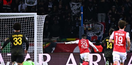 Reims' English forward Folarin Balogun (C) shoots and scores his team's first goal during the French L1 football match between Paris Saint-Germain (PSG) and Stade de Reims at the Parc des Princes stadium in Paris on January 29, 2023. (Photo by ANNE-CHRISTINE POUJOULAT/AFP via Getty Images)