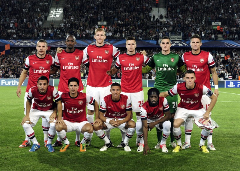 Arsenal's players pose before the UEFA Champions League football match Montpellier vs. Arsenal on September 18, 2012 at the La Mosson stadium in Montpellier. Top row, from left : German forward Lucas Podolski, French midfielder Vassiriki Diaby, German defender Per Mertesacker, Finnish defender Carl Jenkinson, Italian goalkeeper Vito Mannone, and French forward Olivier Giroud. Bottom row, from left: Spain midfielder Santiago Cazorla, Spain midfielder Mikel Arteta, British defender Kieran Gibbs, Ivorian forward Gervinho, and Belgian defender Thomas Vermaelen. AFP PHOTO / PASCAL GUYOT (Photo credit should read PASCAL GUYOT/AFP/GettyImages)