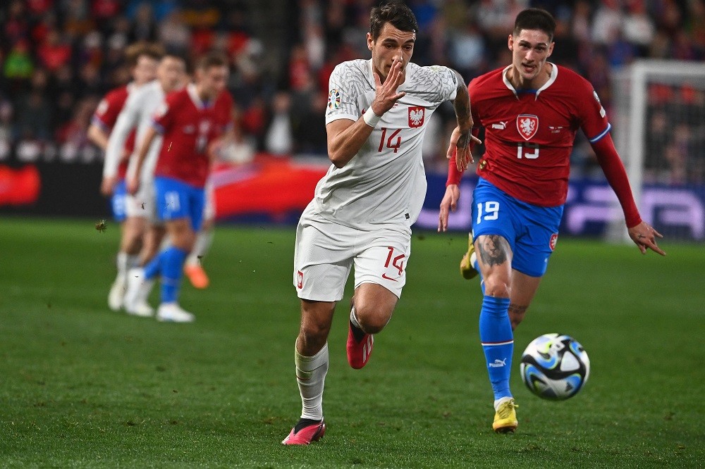 Czech Republic's forward Tomas Cvancara and Poland's defender Jakub Piotr Kiwior vie for the ball during the UEFA Euro 2024 Group E qualification m...