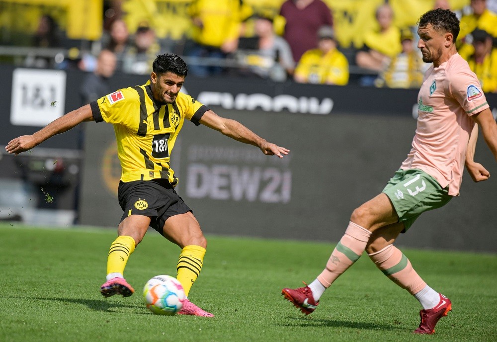 Dortmund's German midfielder Mahmoud Dahoud (L) and Bremen's Serbian defender Milos Veljkovic vie for the ball during the German first division Bundesliga football match between Borussia Dortmund and SV Werder Bremen in Dortmund, western Germany, on August 20, 2022. (Photo by SASCHA SCHUERMANN/AFP via Getty Images)
