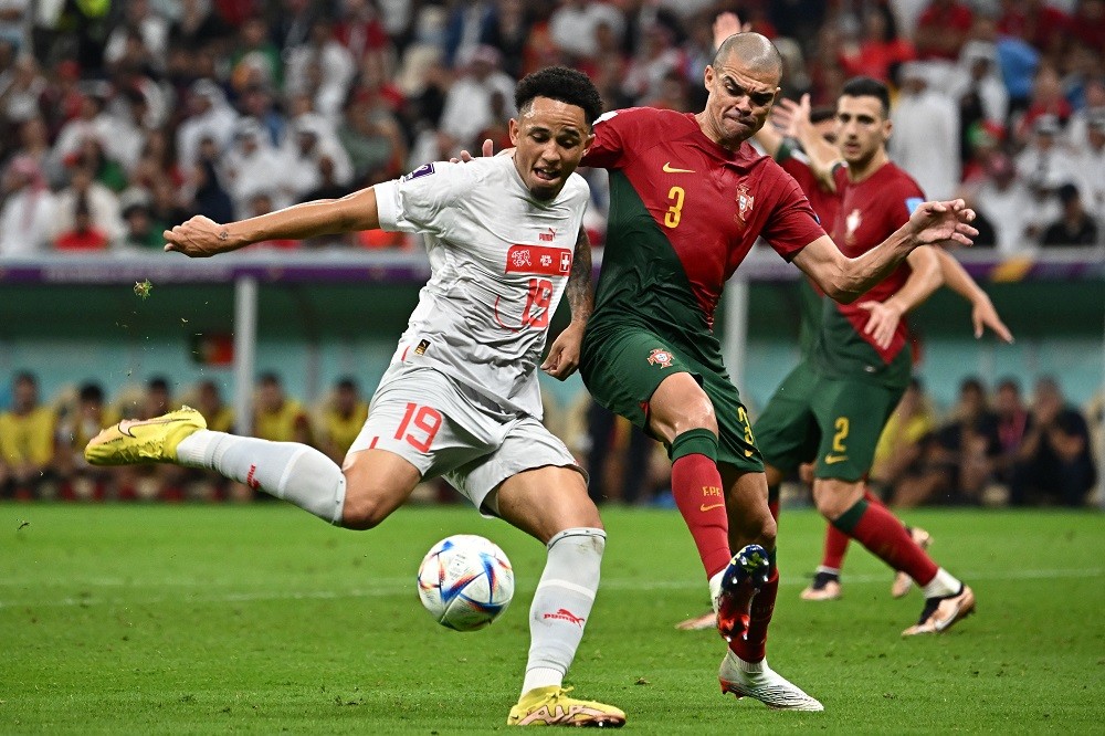 Switzerland's forward Noah Okafor and Portugal's defender Pepe fight for the ball during the Qatar 2022 World Cup round-of-16 football match betwee...