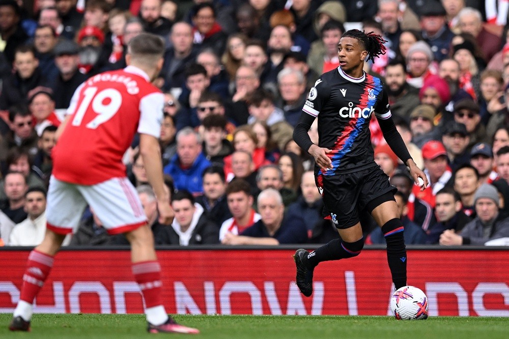 Crystal Palace's French midfielder Michael Olise (R) runs with the ball during the English Premier League football match between Arsenal and Crystal Palace at the Emirates Stadium in London on March 19, 2023. (Photo by JUSTIN TALLIS/AFP via Getty Images)