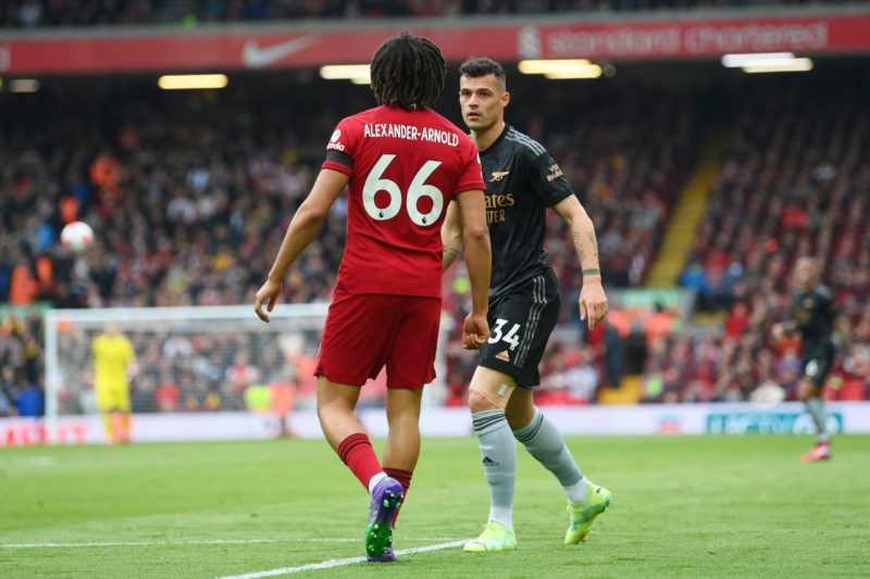 LIVERPOOL, ENGLAND - APRIL 09: Trent Alexander-Arnold of Liverpool confronts Granit Xhaka of Arsenal during the Premier League match between Liverpool FC and Arsenal FC at Anfield on April 09, 2023 in Liverpool, England. (Photo by Shaun Botterill/Getty Images)