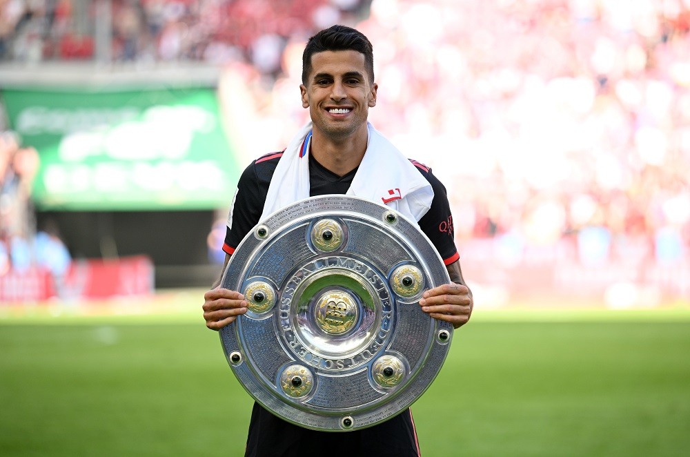 Arsenal gossip - COLOGNE, GERMANY: Joao Cancelo of FC Bayern Munich poses for a photo with the Bundesliga Meisterschale trophy after the team's vic...