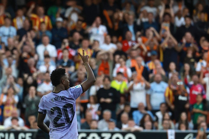 Former Arsenal man explains comments after racial abuse of Real Madrid's Vini Jr 5 Real Madrid's Brazilian forward Vinicius Junior gestures to the stands during the Spanish league football match between Valencia CF and Real Madrid CF at the Mestalla stadium in Valencia on May 21, 2023. (Photo by JOSE JORDAN/AFP via Getty Images)
