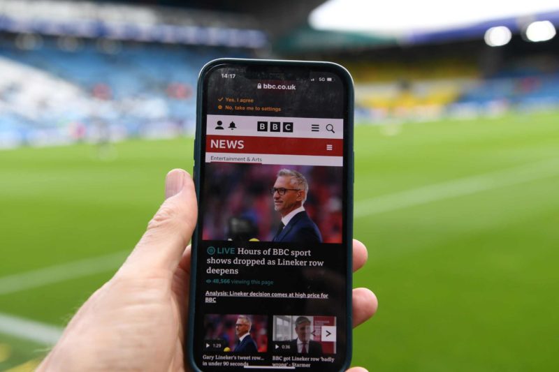 LEEDS, ENGLAND - MARCH 11: A detailed view of a phone with the BBC News website displaying a story of Gary Lineker is seen inside the stadium prior...