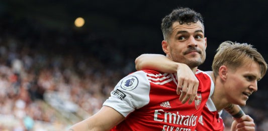 TOPSHOT - Arsenal's Swiss midfielder Granit Xhaka and Arsenal's Norwegian midfielder Martin Odegaard (R) celebrates their team's second goal during the English Premier League football match between Newcastle United and Arsenal at St James' Park in Newcastle-upon-Tyne, north east England on May 7, 2023. (Photo by LINDSEY PARNABY/AFP via Getty Images)