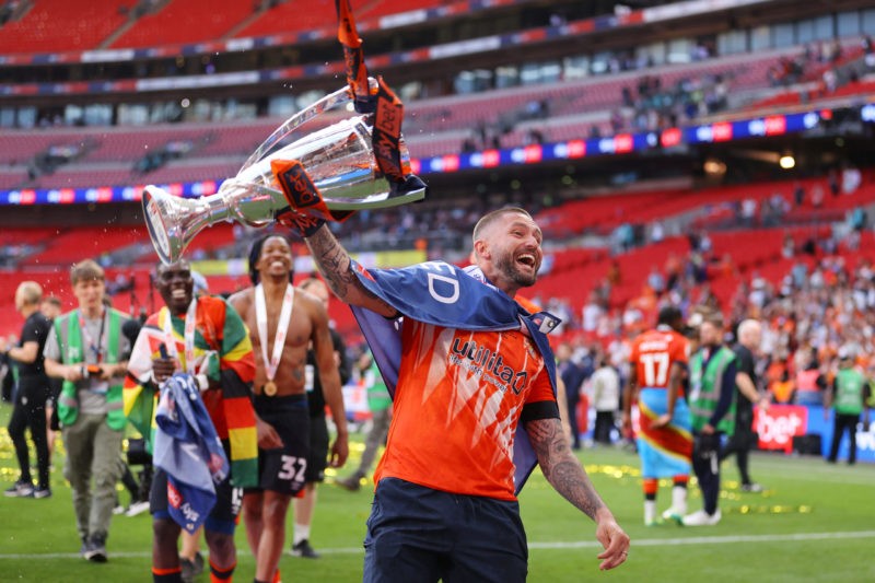 LONDON, ENGLAND - MAY 27: Henri Lansbury of Luton Town celebrates with the Sky Bet Championship Play Offs Final trophy following the team’s victory...