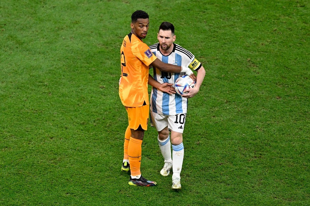 Netherlands' defender Jurrien Timber (L) blocks Argentina's forward #10 Lionel Messi during the Qatar 2022 World Cup quarter-final football match between The Netherlands and Argentina at Lusail Stadium, north of Doha on December 9, 2022. (Photo by PATRICIA DE MELO MOREIRA/AFP via Getty Images)