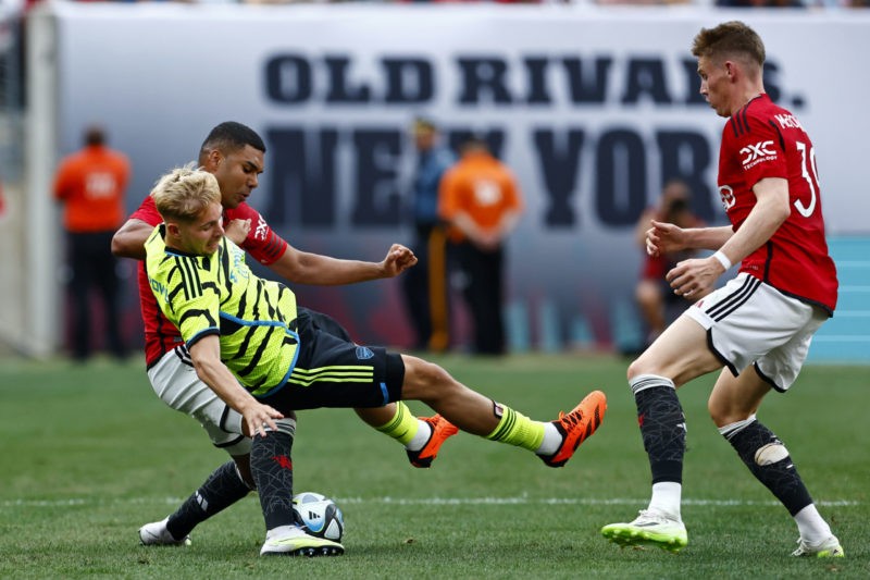 Arsenal midfielder admits fight ahead for place in team 2 EAST RUTHERFORD, NEW JERSEY - JULY 22: Emile Smith Rowe (C) #10 of Arsenal is pulled down by Casemiro #18 of Manchester United during the second half of a pre-season friendly match at MetLife Stadium on July 22, 2023 in East Rutherford, New Jersey. Manchester United defeated Arsenal 2-0. (Photo by Rich Schultz/Getty Images)