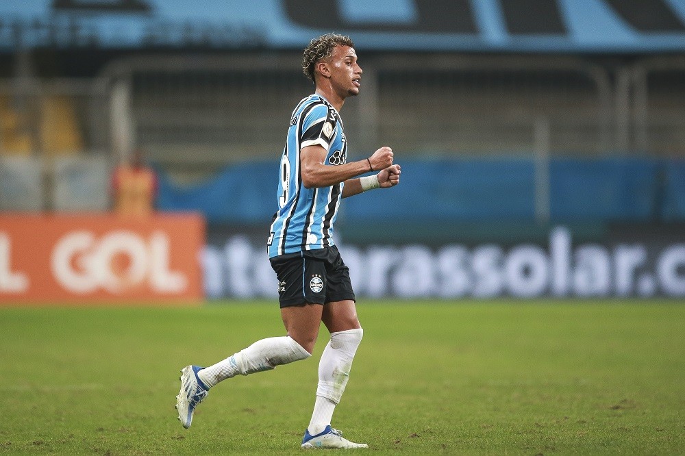PORTO ALEGRE, BRAZIL: Bitello of Gremio celebrates after scoring the team's third goal during a Brasileirao match between Gremio and Internacional ...