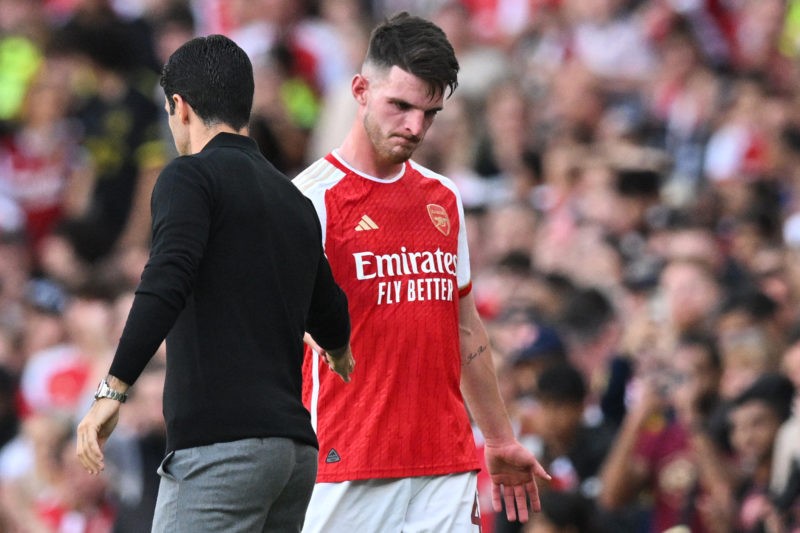 Arsenal's Spanish manager Mikel Arteta (L) shakes hands with Arsenal's English midfielder Declan Rice as he leaves the pitch during the pre-season ...