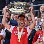 Arsenal's English midfielder Declan Rice (C) lifts the trophy after Arsenal win the shoot-out after the English FA Community Shield football match between Arsenal and Manchester City at Wembley Stadium, in London, August 6, 2023. Arsenal won after a 4-1 penalty shoot-out win, following the 1-1 draw in 90 minutes. (Photo by GLYN KIRK/AFP via Getty Images)