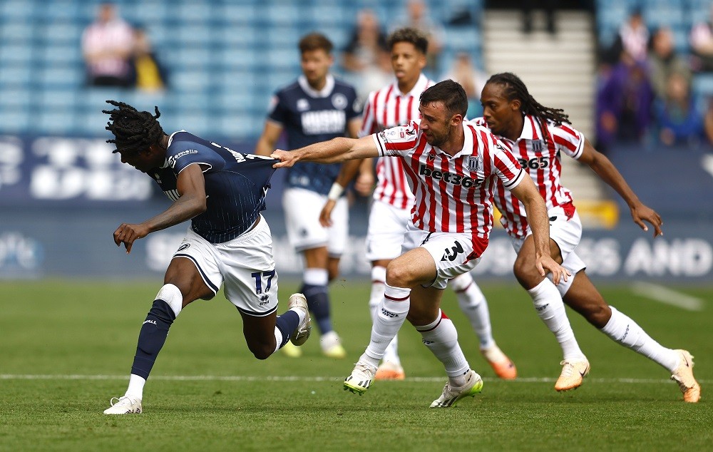 SLONDON, ENGLAND: Stoke City's Enda Stevens pulls at the shirt of Brooke Norton-Cuffy during the Sky Bet Championship match between Millwall and St...