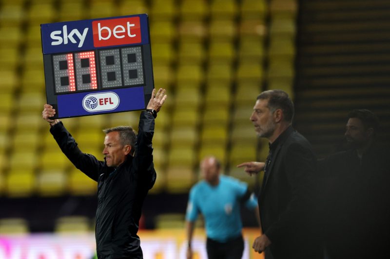 WATFORD, ENGLAND - OCTOBER 05: The assistant referee holds up the board with 17 minutes of added time during the Sky Bet Championship match between...