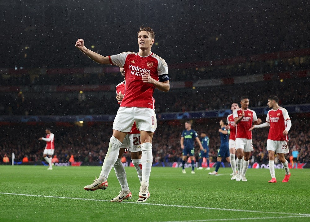 LONDON, ENGLAND: Martin Odegaard of Arsenal celebrates scoring the fourth goal during the UEFA Champions League match between Arsenal FC and PSV Ei...