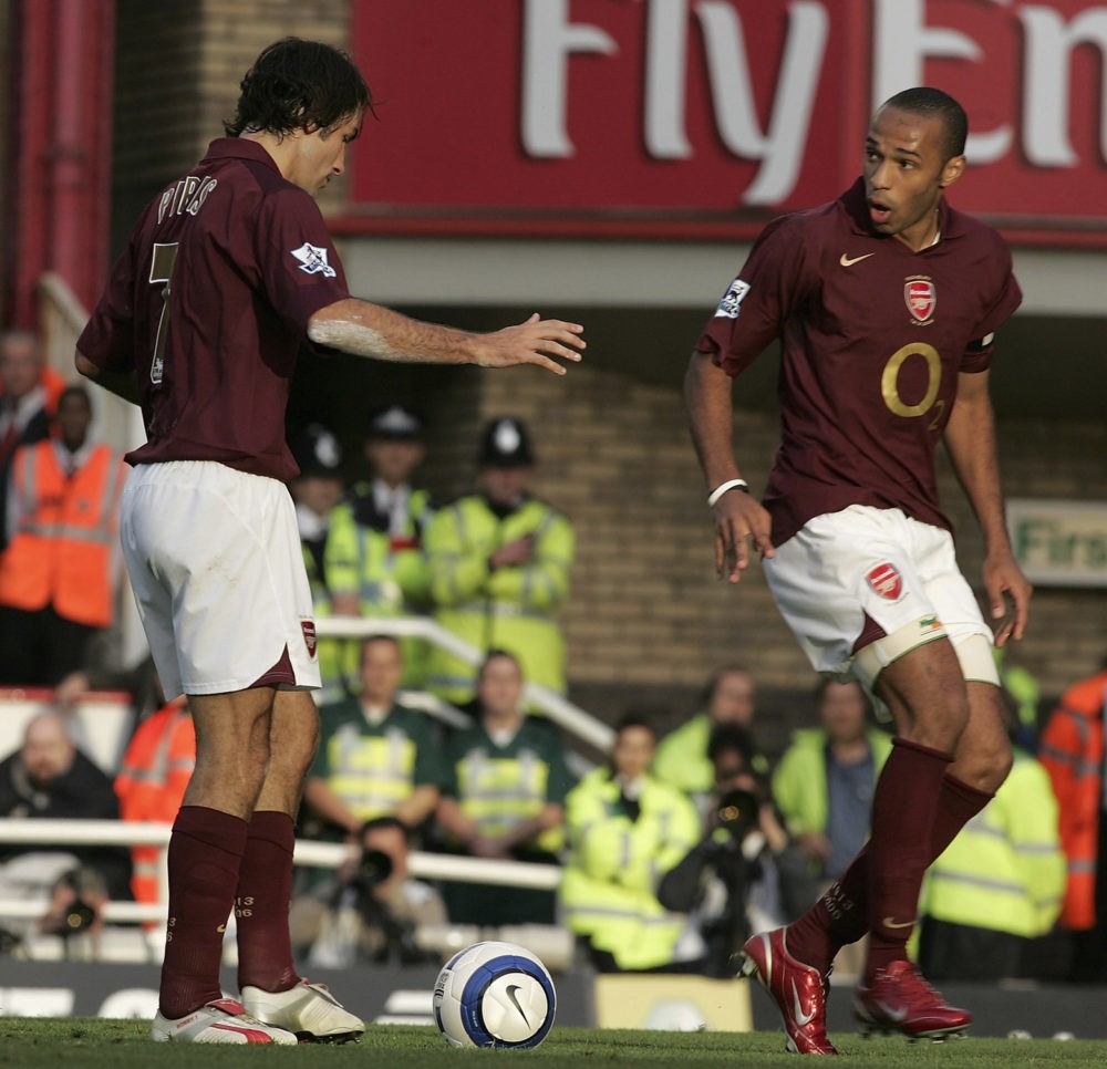 LONDON: Robert Pires of Arsenal looks at Thierry Henry after the confusion between them caused them to miss a penalty during the Barclays Premiersh...