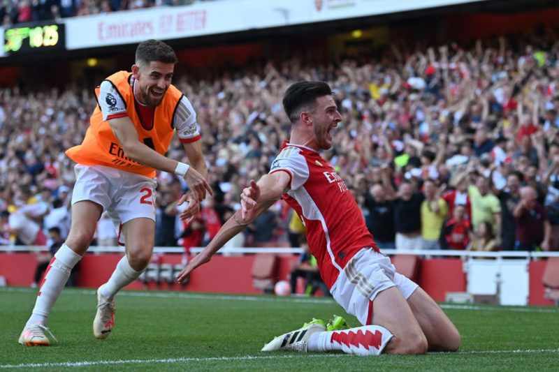 Arsenal's English midfielder #41 Declan Rice celebrates with Arsenal's Italian midfielder #20 Jorginho (L) after scoring their late second goal during the English Premier League football match between Arsenal and Manchester United at the Emirates Stadium in London on September 3, 2023. (Photo by GLYN KIRK/AFP via Getty Images)