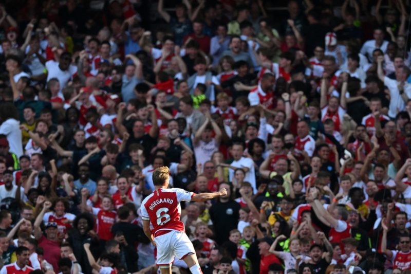 Arsenal's Norwegian midfielder #08 Martin Odegaard celebrates in front of fans after scoring their first goal during the English Premier League foo...