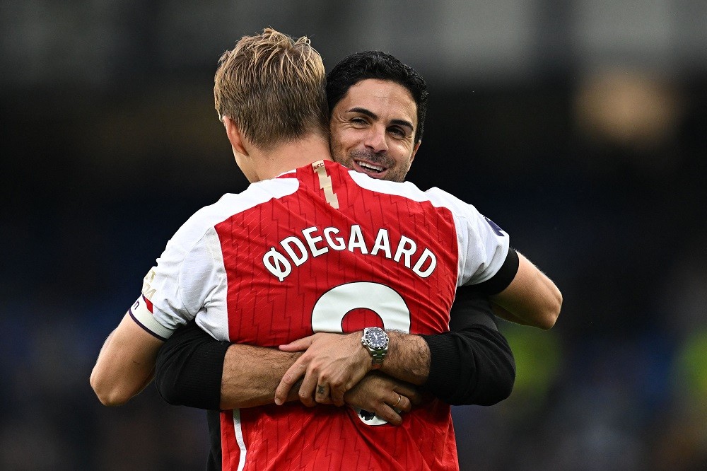 Martin Odegaard reacts to his new Arsenal chant 2 Arsenal's Norwegian midfielder Martin Odegaard is embraced by Arsenal's Spanish manager Mikel Arteta on the pitch after the English Premier League football match between Everton and Arsenal at Goodison Park in Liverpool, north west England on September 17, 2023. (Photo by PAUL ELLIS/AFP via Getty Images)