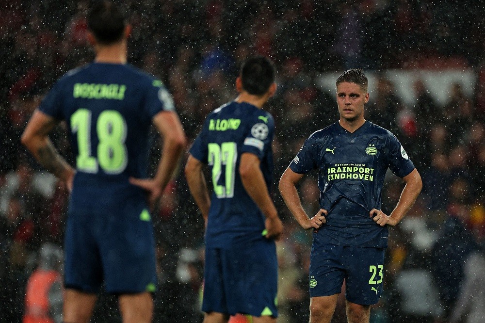 PSV Eindhoven's Olivier Boscagli (L), Hirving Lozano (C), and Joey Veerman react after the UEFA Champions League Group B football match between Ars...
