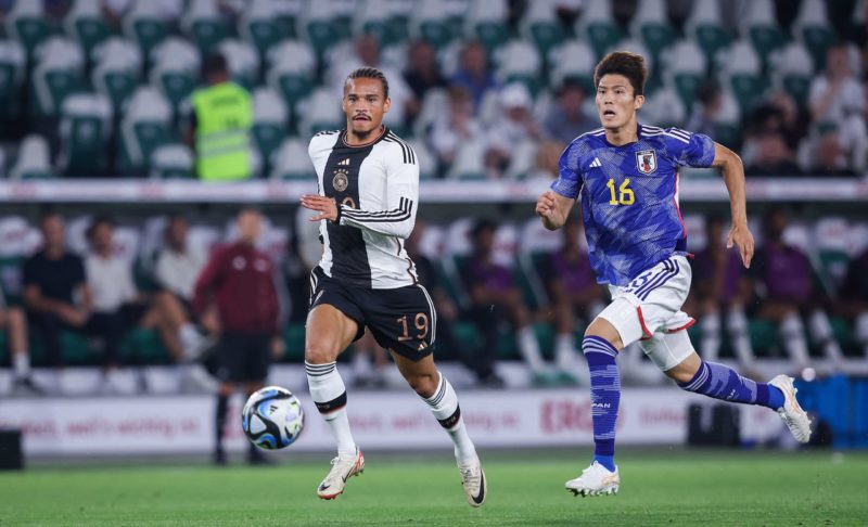 Germany's midfielder #19 Leroy Sane (L) and Japan's defender #16 Takehiro Tomiyasu vie for the ball during the friendly football match between Germany and Japan at the Volkswagen Arena in Wolfsburg, central Germany, on September 9, 2023. (Photo by RONNY HARTMANN/AFP via Getty Images)
