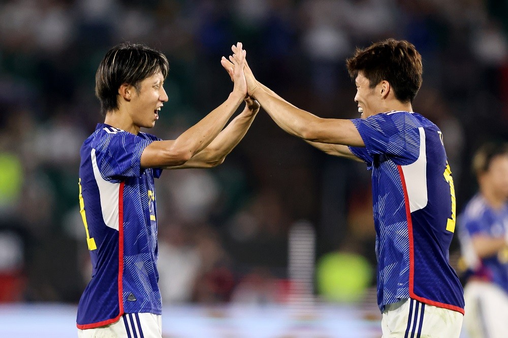 WOLFSBURG, GERMANY: Hiroki Ito and Takehiro Tomiyasu of Japan celebrate victory after the international friendly match between Germany and Japan at...