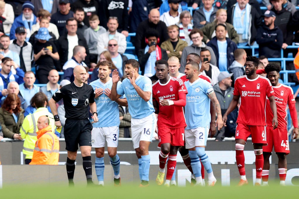 MANCHESTER, ENGLAND - SEPTEMBER 23: Rodri of Manchester City speaks to Match Referee Anthony Taylor after being shown a red card during the Premier League match between Manchester City and Nottingham Forest at Etihad Stadium on September 23, 2023 in Manchester, England. (Photo by George Wood/Getty Images)