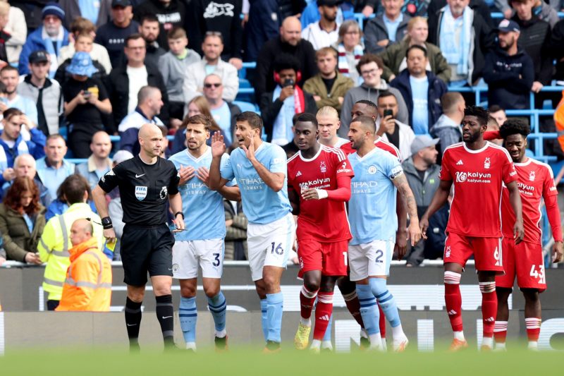 MANCHESTER, ENGLAND - SEPTEMBER 23: Rodri of Manchester City speaks to Match Referee Anthony Taylor after being shown a red card during the Premier League match between Manchester City and Nottingham Forest at Etihad Stadium on September 23, 2023 in Manchester, England. (Photo by George Wood/Getty Images)