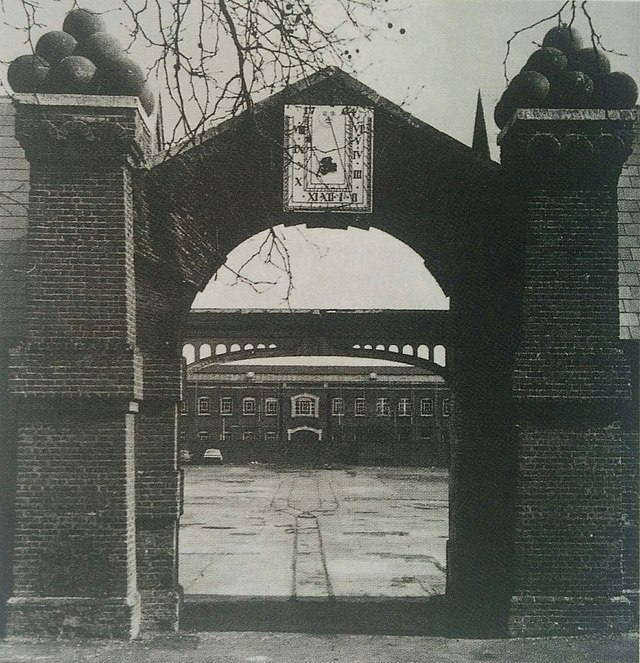 Historical photo of the arch joining two workshops and leading into Dial Square. The arch still stands today. [photo by unknown]