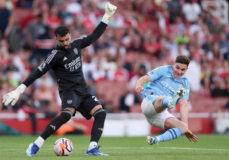 Did Emi Martinez accidentally reveal Aaron Ramsdale's next club? 4 LONDON, ENGLAND - OCTOBER 08: David Raya of Arsenal is challenged by Julian Alvarez of Manchester City during the Premier League match between Arsenal FC and Manchester City at Emirates Stadium on October 08, 2023 in London, England. (Photo by Alex Pantling/Getty Images)