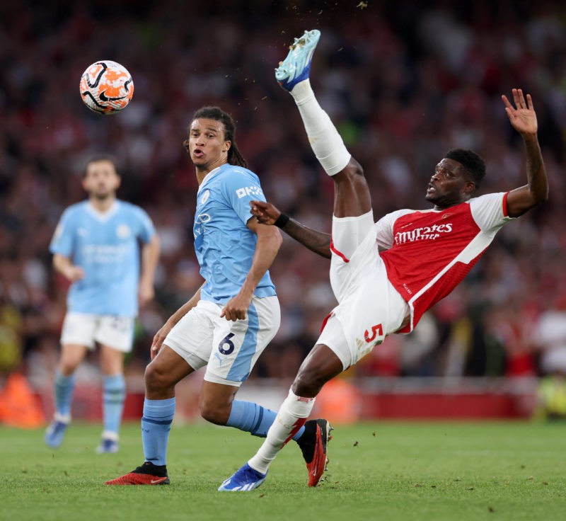 LONDON, ENGLAND - OCTOBER 08: Thomas Partey of Arsenal controls the ball whilst under pressure from Nathan Ake of Manchester City during the Premie...