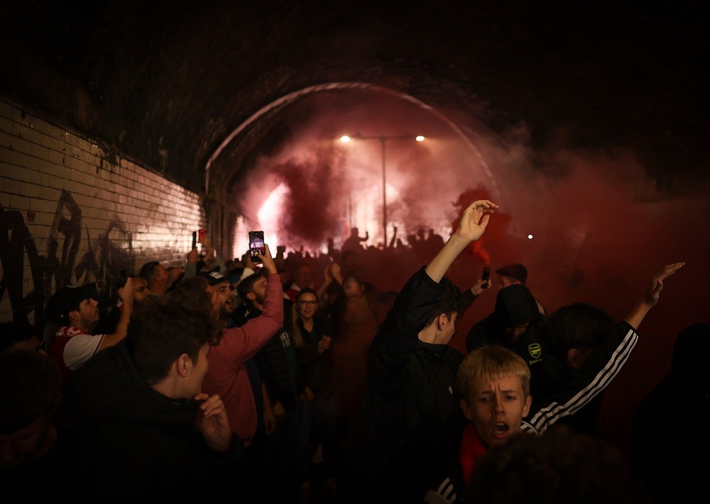 LONDON, ENGLAND: Arsenal fans show their support with flares on their way to the stadium prior to the Premier League match between Arsenal FC and T...