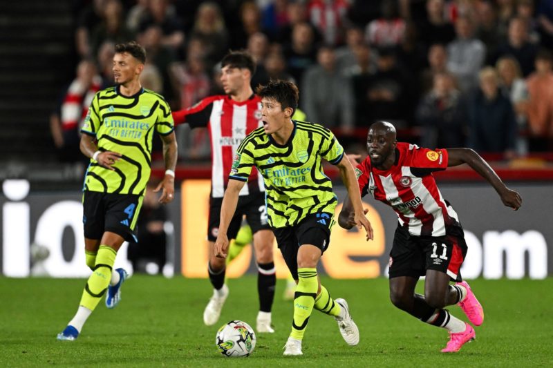 Arsenal's Japanese defender #18 Takehiro Tomiyasu controls the ball past Brentford's French-born DR Congo striker #11 Yoane Wissa during the English League Cup third round football match between Brentford and Arsenal at the Brentford Community Stadium in London on September 27, 2023. (Photo by JUSTIN TALLIS/AFP via Getty Images)