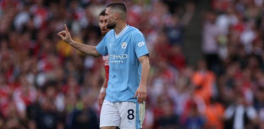 Arsenal's Norwegian midfielder #08 Martin Odegaard (R) reacts after being fouled by Manchester City's Croatian midfielder #08 Mateo Kovacic (C) during the English Premier League football match between Arsenal and Manchester City at the Emirates Stadium in London on October 8, 2023. (Photo by ADRIAN DENNIS/AFP via Getty Images)