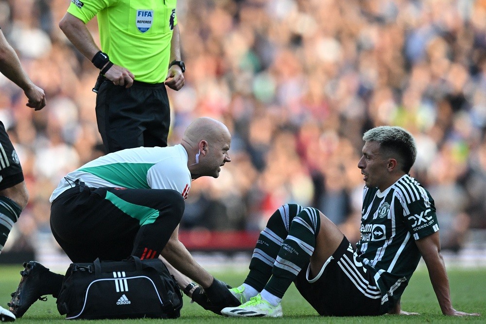 Manchester United's Lisandro Martinez receives medical attention during the English Premier League football match between Arsenal and Manchester Un...