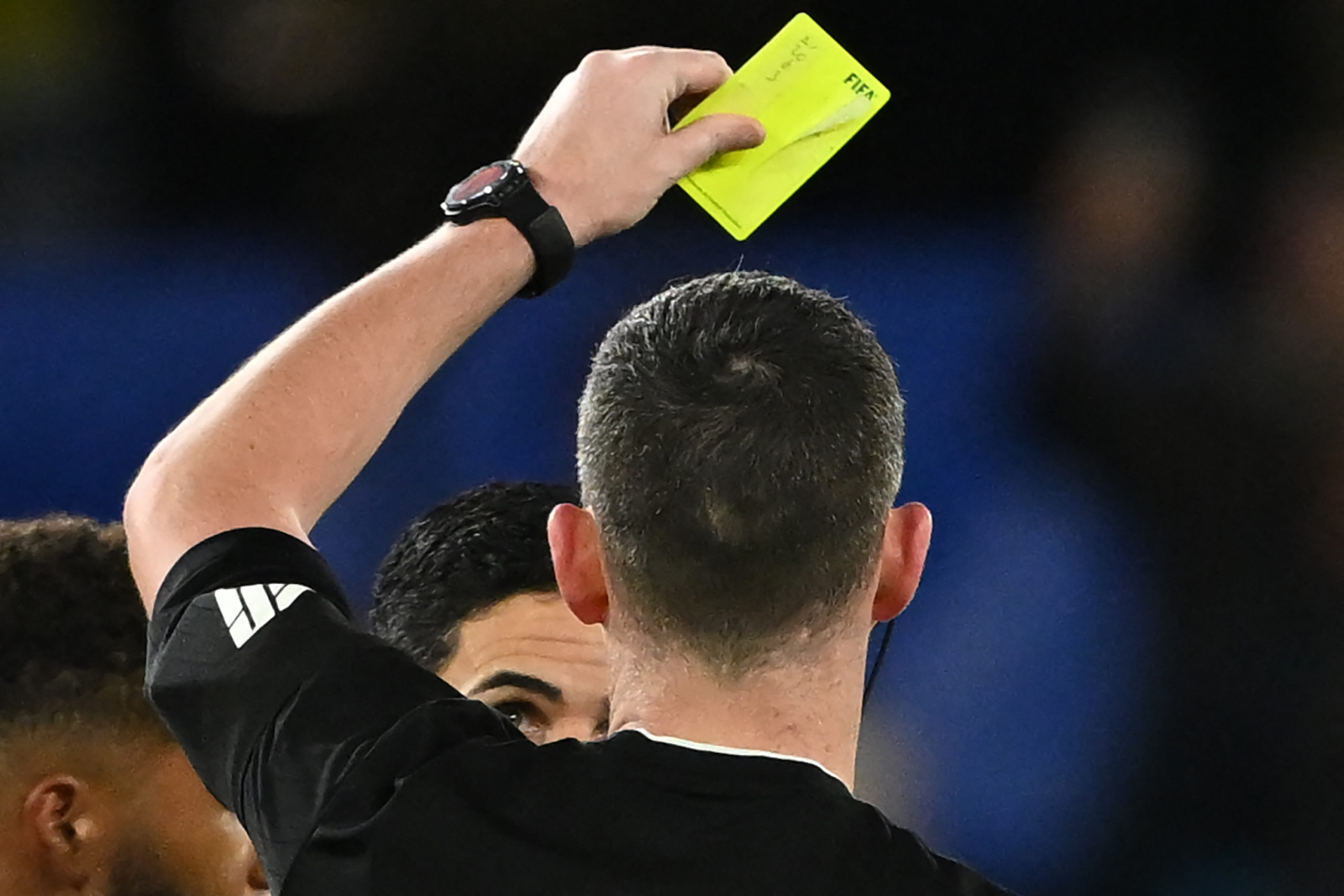 Arsenal's Spanish manager Mikel Arteta is shown a yellow card after speaking to English referee Chris Kavanagh after the English Premier League foo...