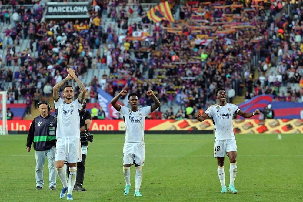 Journalist clarifies Arsenal links to Real Madrid star 2 Real Madrid's Joselu, Vinicius Junior, and Aurelien Tchouameni celebrate their win at the end of the Spanish league football match between FC Barcelona and Real Madrid CF at the Estadi Olimpic Lluis Companys in Barcelona on October 28, 2023. (Photo by LLUIS GENE/AFP via Getty Images)