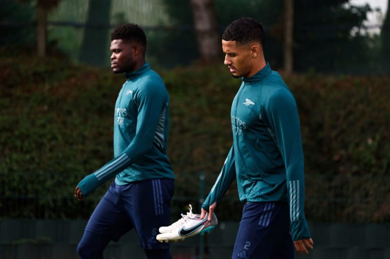 Arsenal's Ghanaian midfielder #05 Thomas Partey and Arsenal's French defender #02 William Saliba arrive to attend a team training session at Arsenal's training ground in north London on October 23, 2023, ahead of their UEFA Champions League Group B football match against Sevilla FC. (Photo by HENRY NICHOLLS/AFP via Getty Images)