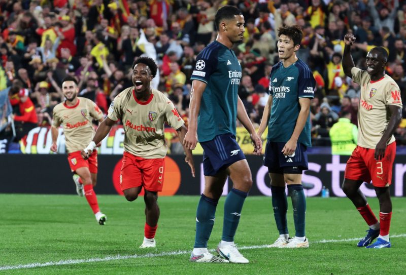 Lens' French forward #09 Elye Wahi (L) celebrates after scoring a goal his team's second goal during the UEFA Champions League Group B first leg football match between RC Lens and Arsenal FC at the Bollaert Stadium in Lens, northern France, on October 3, 2023. (Photo by DENIS CHARLET/AFP via Getty Images)