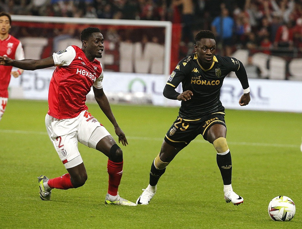 Reims' defender #2 Joseph Okumu (L) fights for the ball with Monaco's forward #29 Folarin Balogun (R) during the French L1 football match between S...