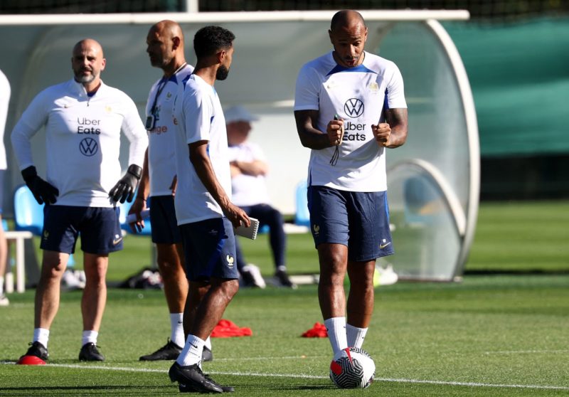 Former French football player and newly appointed France U21 head coach Thierry Henry (R) speaks with assistant coach Gael Clichy during a training...