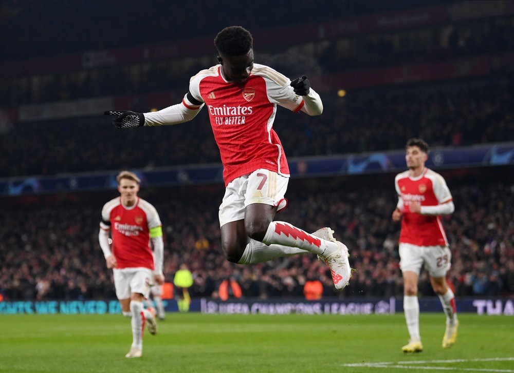 LONDON, ENGLAND: Bukayo Saka of Arsenal celebrates after scoring the team's third goal during the UEFA Champions League match between Arsenal FC an...