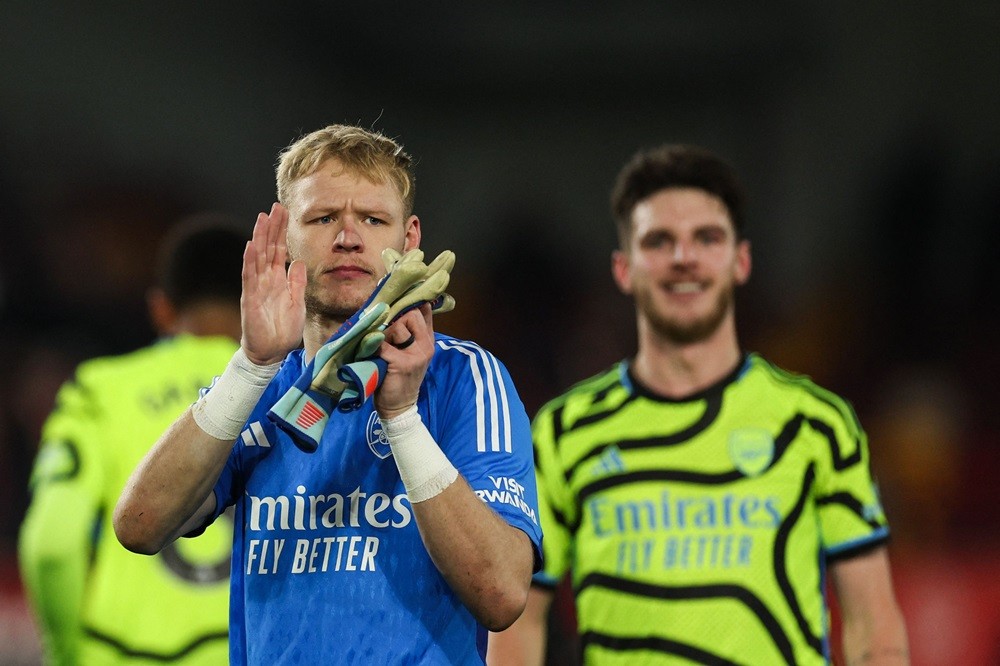 Arsenal's Aaron Ramsdale applauds as he celebrates at the end of the English Premier League football match between Brentford and Arsenal at the Gte...