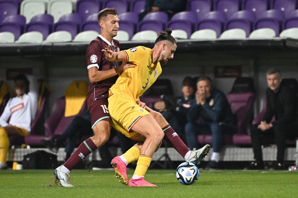 Romania defender Radu Dragusin (R) and Belarus midfielder Vladislav Klimovich vie for the ball during the UEFA Euro 2024 group I qualification football match Belarus v Romania at the Szusza Ferenc stadium of Budapest, Hungary on October 12, 2023. (Photo by ATTILA KISBENEDEK/AFP via Getty Images)
