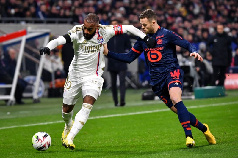 Lyon's French forward #10 Alexandre Lacazette (L) fights for the ball with Lille's Swedish defender #05 Gabriel Gudmundsson (R) during the French L1 football match between Olympique Lyonnais (Lyon) and LOSC (Lille) at the Groupama stadium in Lyon, central eastern France on November 26, 2023. (Photo by ARNAUD FINISTRE/AFP via Getty Images)