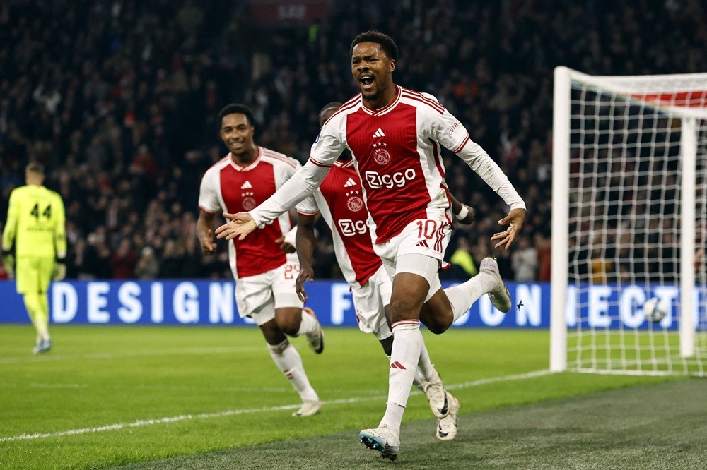 Ajax's Chuba Akpom (R) celebrates after scoring his team's third goal during the Dutch Eredivisie match between Ajax Amsterdam and SC Heerenveen at...